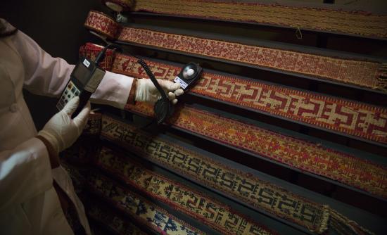 Trabajadora realiza mediciones en colección de trariwe mapuche